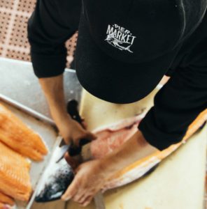 chef cutting salmon from above
