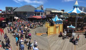 Crowds gathered around some of the fun attractions at Pier 39