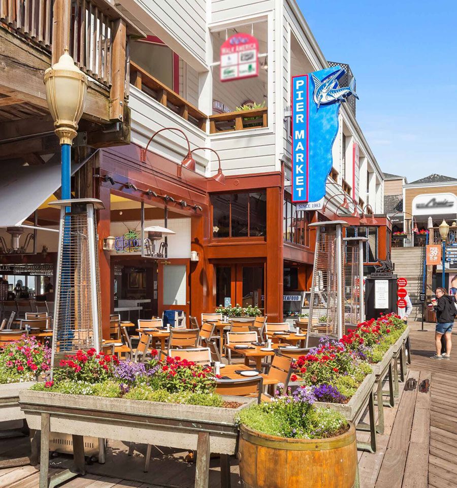 Exterior shot of Pier Market Seafood Restaurant showing the al fresco dining area