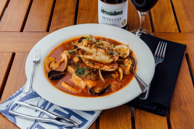 Cioppino served with wine.