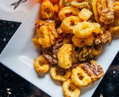 Fried calamari on a white plate.