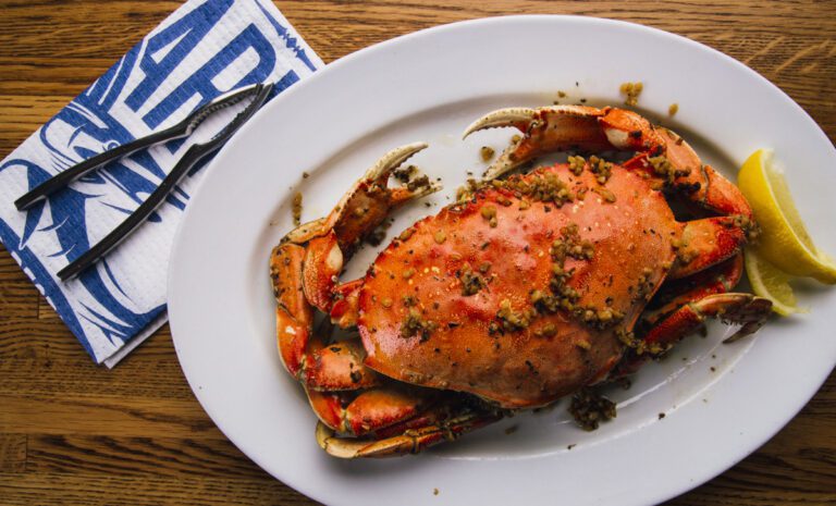 A plate of Pier Market Garlic Roasted Whole Dungeness Crab