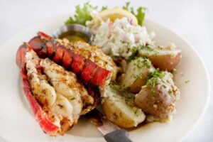 Grilled lobster tail on a plate.